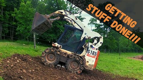 spread dirt with skid steer|Skid Steer placing rubble, loading and spreading topsoil .